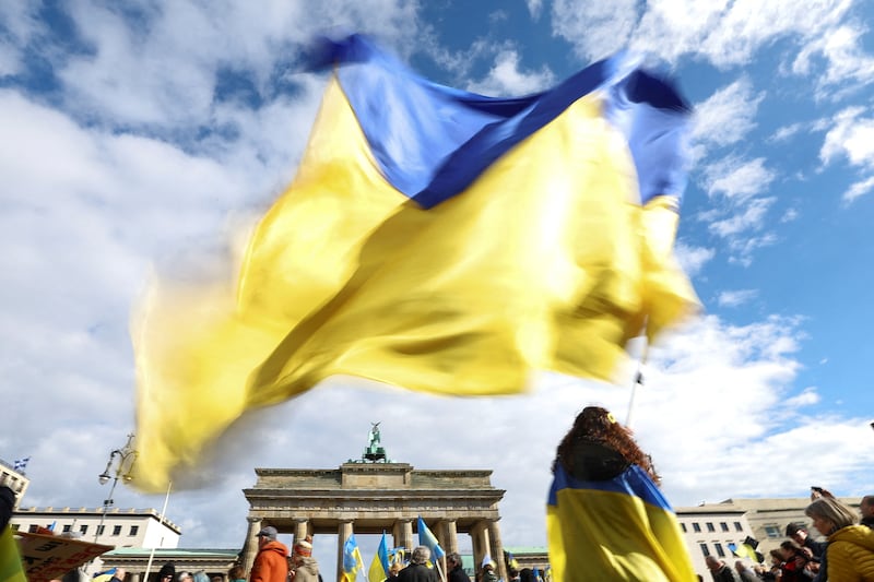 A person waves a Ukrainian flag in Berlin. Reuters