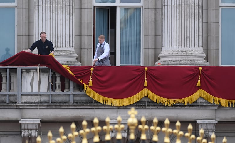 Members of staff prepare the balcony of Buckingham Palace. EPA