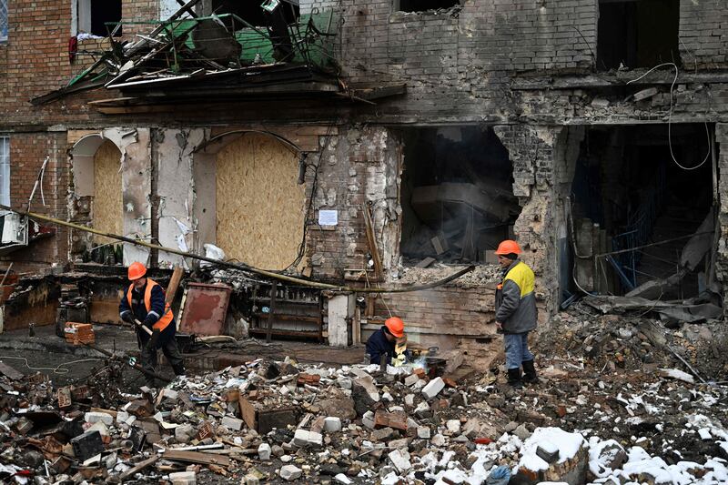 Repairmen work near a residential building damaged following a  missile attack in Vyshgorod, outside of Kyiv. AFP