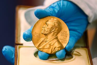 A national library employee shows a gold Nobel Prize medal in Bogota, Colombia. AP Photo