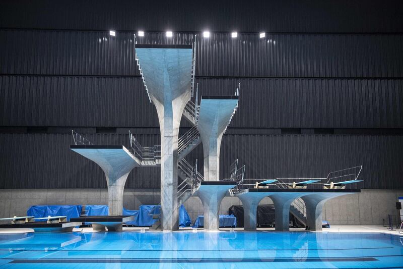 This picture shows a general view of the Tokyo Aquatics Centre - the venue for swimming, diving and artistic swimming at the 2020 Tokyo Olympics and Paralympics Games - during a training session for the Japan Swimming Championships competition in Tokyo on April 6, 2021. / AFP / CHARLY TRIBALLEAU
