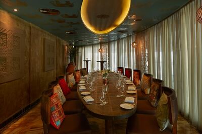 Private dining room with elephant motif wallpaper on the ceiling