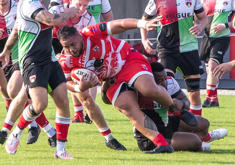 A Dubai Tigers player gets tackled during the game against the Abu Dhabi Harlequins.