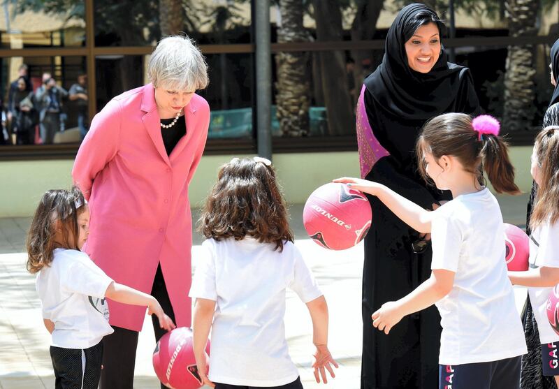 British Prime Minister Theresa May (L) and the Saudi head of the women’s section at the general authority for sports, Princess Reema Bint Bandar al-Saud (R) chat with Saudi girls during a basketball class at the Olympic headquarters in Riyadh on April 5, 2017. (Photo by FAYEZ NURELDINE / AFP POOL / AFP)