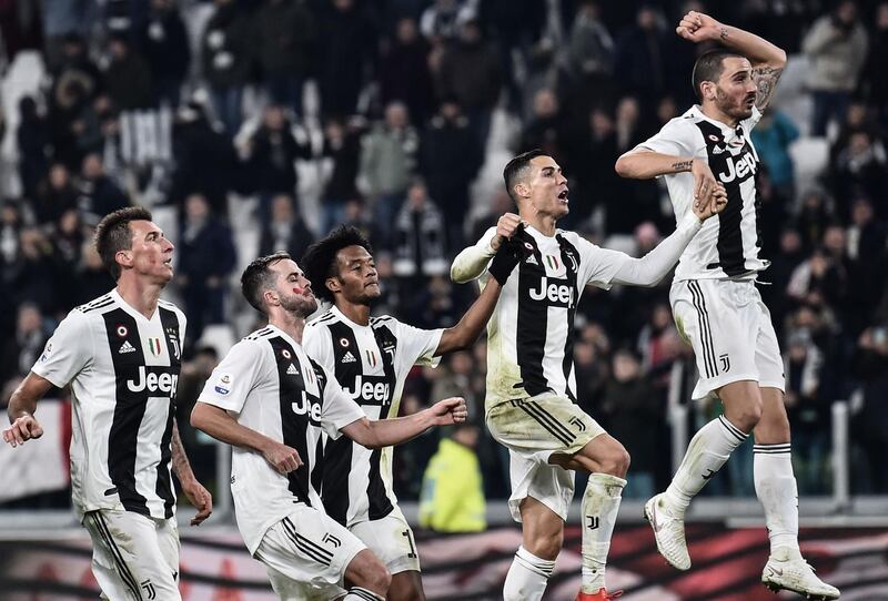 Juventus players celebrate in front of fans after beating SPAL. AFP