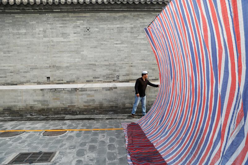 A man reaches behind the screen at the Niujie mosque in Beijing, China. Damir Sagolj / Reuters