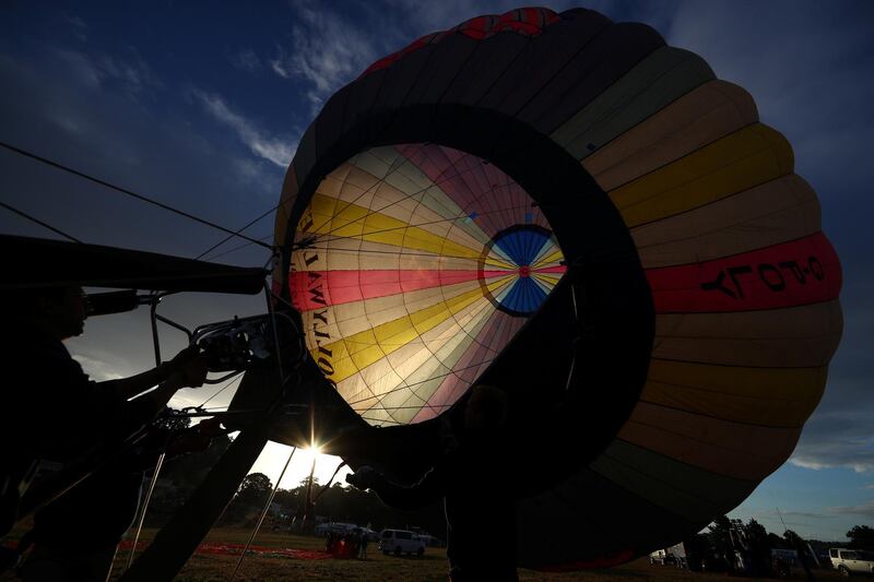 Crew members inflate a balloon during a tethered flight at the Bristol International Balloon fiesta. Reuters
