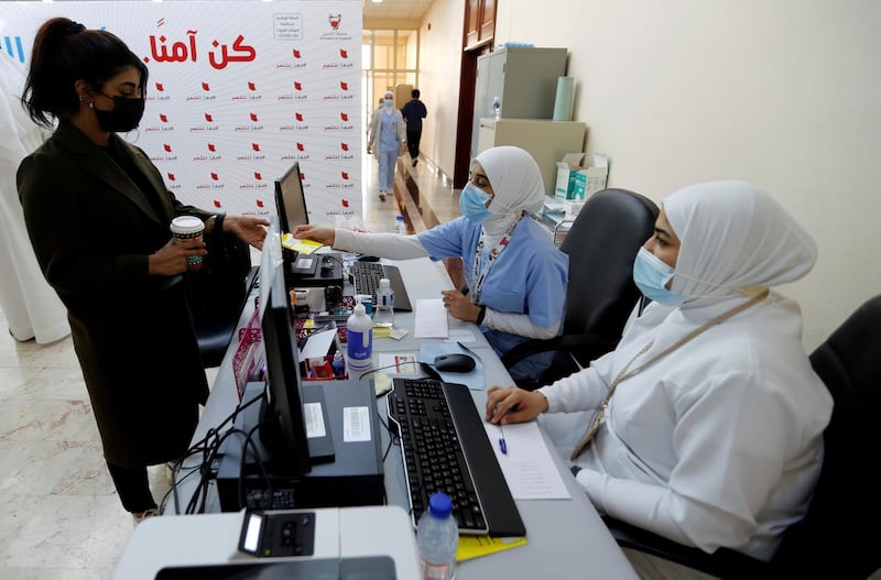 FILE PHOTO: A woman takes her appointment for a second dose of a coronavirus disease (COVID-19) vaccine, at Bahrain International Exhibition & Convention Centre (BIECC), in Manama, Bahrain December 24, 2020. REUTERS/Hamad I Mohammed/File Photo