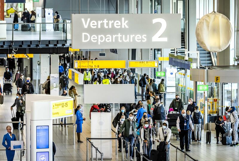 epa08889854 Travellers in the departure hall of Schiphol Amsterdam Airport, in Amsterdam, the Netherlands, 17 December 2020. Tour operators including TUI and Corendon are canceling their air travel to holiday destinations due to increased numbers of people infected with coronavirus Covid-19 in most countries. Schiphol also advises people not to fly if they don't really have to.  EPA/REMKO DE WAAL