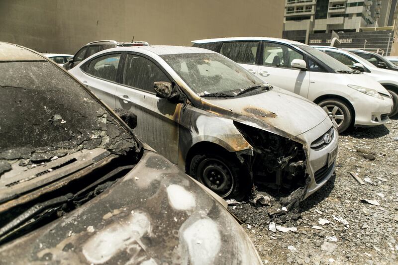 DUBAI, UNITED ARAB EMIRATES - AUG 4: 

Dubai Marina's Torch Tower, one of the world's tallest residential buildings, went up in a fire that started last night. 

Many of the cars parked close where damaged because of the burning debris. 

(Photo by Reem Mohammed/The National)

Section: NA