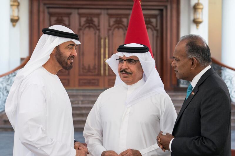 ABU DHABI, UNITED ARAB EMIRATES - March 05, 2018: HH Sheikh Mohamed bin Zayed Al Nahyan Crown Prince of Abu Dhabi Deputy Supreme Commander of the UAE Armed Forces (L), speaks with Sheikh Rashid bin Abdullah Al Khalifa Minister of Interior of Bahrain (C) and K Shanmugam Minister for Home Affairs & Law of Singapore (R), while receiving a delegation of the International Security Alliance, during a Sea Palace barza. 
( Ryan Carter for the Crown Prince Court - Abu Dhabi )