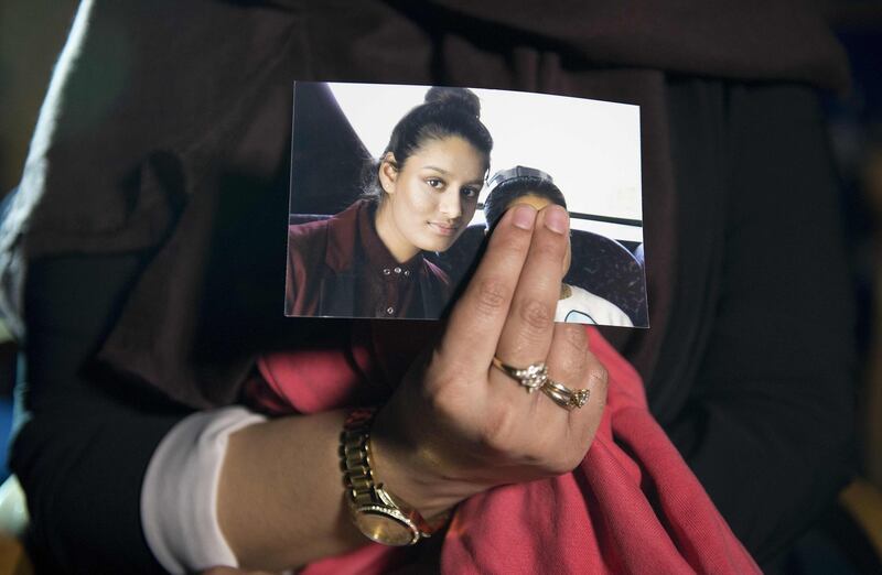 (FILES) In this file photo taken on February 22, 2015 Renu Begum, eldest sister of missing British girl Shamima Begum, holds a picture of her sister while being interviewed by the media in central London. A British teenager who fled to join the Islamic State group in Syria is living in a refugee camp and wants to return home, The Times reported on February 14, 2019. Shamima Begum, now 19, expressed no regrets about fleeing her London life four years ago but said that two of her children had died and, pregnant with her third, she wanted to return. / AFP / POOL / POOL / LAURA LEAN
