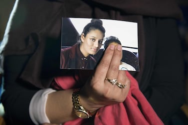 Renu Begum holds a picture of her sister Shamima Begum. AFP 