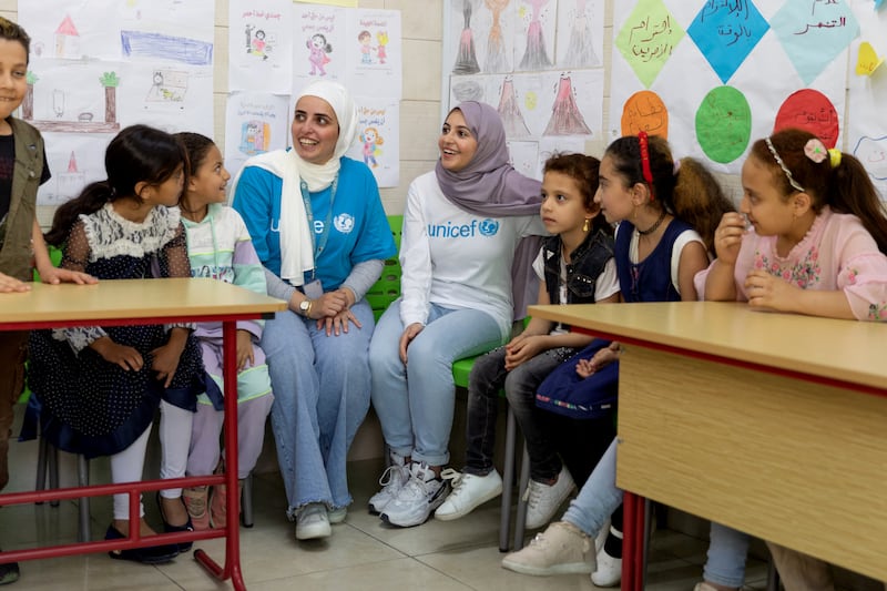Muzoon Almellehan, centre right, and Alaa Khaled Hasan, centre left, sit in on a child protection session in East Amman.
