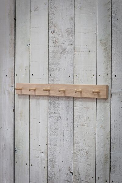A peg rail is a good place to hang scarves, belts and other accessories. Garden Trading 