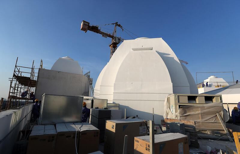 Work under way on one of five temple domes in December. Pawan Singh / The National