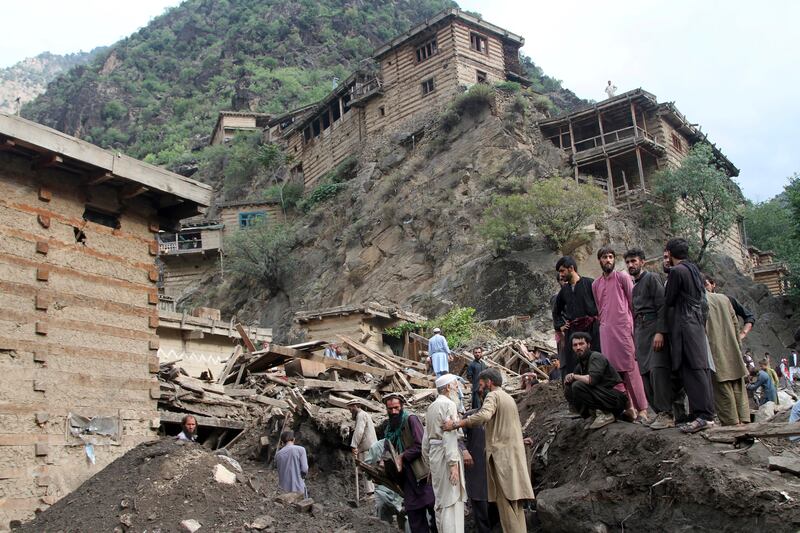 People search for victims of a mudslide after heavy flooding in Nuristan province, east of Kabul, Afghanistan.