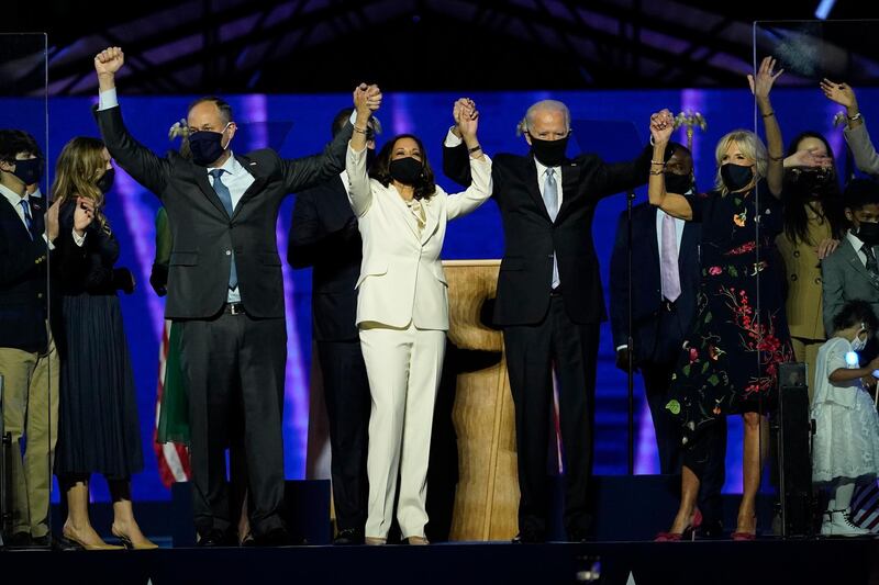 From left, Doug Emhoff, husband of Vice President-elect Kamala Harris, Harris, President-elect Joe Biden and his wife Jill Biden on stage together, Saturday, Nov. 7, 2020, in Wilmington, Del. (AP Photo/Andrew Harnik, Pool)