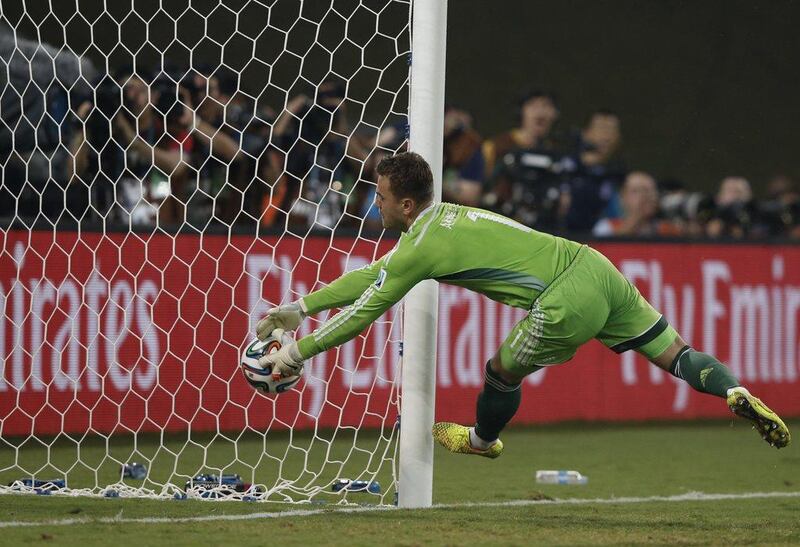 Russia goalkeeper Igor Akinfeev fails to keep the ball from crossing the goal-line, allowing South Korea's only score on Tuesday in their match at the 2014 World Cup. Adrian Dennis / AFP