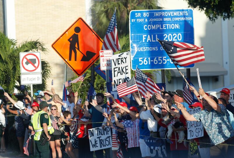 Supporters are seen on the streets in West Palm Beach, Florida, as Donald Trump drives past Thursday, April 18, 2019. AP Photo