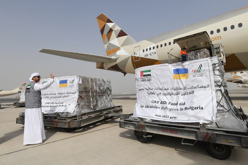 The plane is being loaded with food packets. 