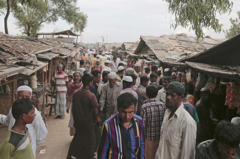 Rohingya Muslims from Myanmar make their way through an alley at an unregistered refugee camp in Teknaf, Bangladesh. AM Ahad / AP