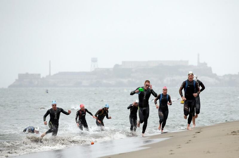 Athletes exit the water during the Escape from Alcatraz Triathlon on Sunday. Ezra Shaw / Getty Images / AFP / June 1, 2014