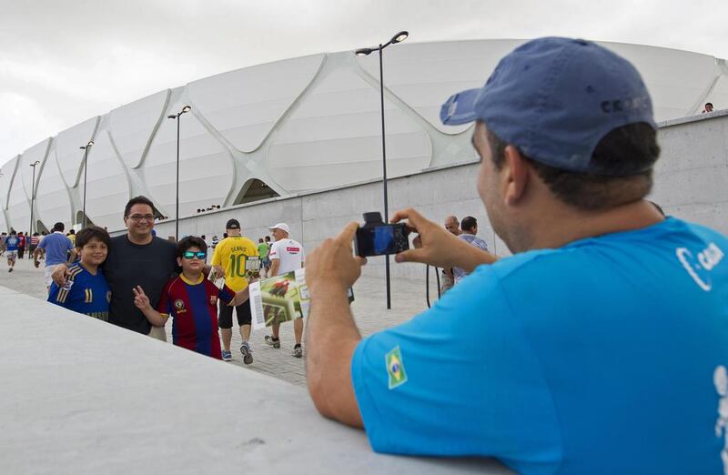 Fans take a photo outside the Arena Amazonia Vivaldo Lima on Sunday. Bruno Kelly / Reuters / March 9, 2014