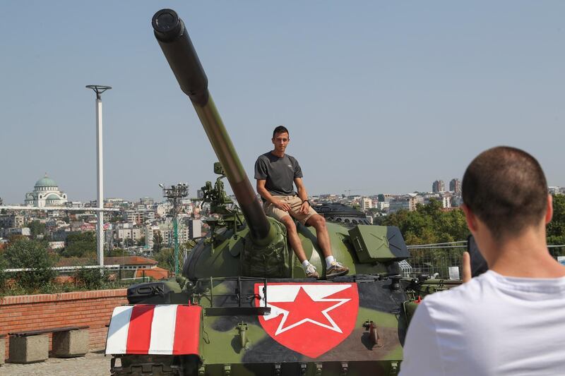 A Red Star Belgrade fan sits on the Soviet-made T-55 main battle tank in front of Rajko Mitic stadium. Reuters