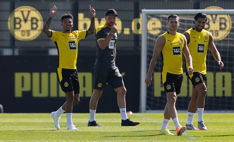 Jadon Sancho, left, with Emre Can and his Borussia Dortmund teammates during training on Thursday, August 6.