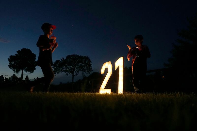 People gather for a candlelight vigil honouring the victims of last year's elementary school shooting in Uvalde, Texas. AP
