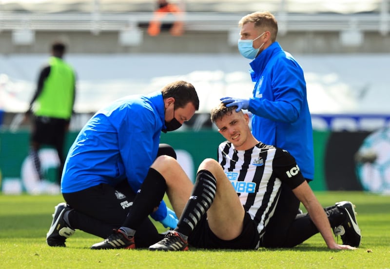 Newcastle United's Ciaran Clark receives medical attention after sustaining an injury. Reuters