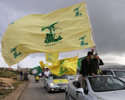 A supporter of Lebanon's Hezbollah gestures as he holds a Hezbollah flag in Marjayoun, Lebanon May 7, 2018. REUTERS/Aziz Taher