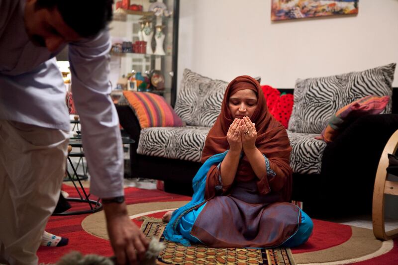 Joined by her husband  Muhammad Noman Amin, Saadia Noman,  prays during their iftar on Tuesday evening, August 2, 2011, the second day of Ramadan, in the living room of their home in the Khalidiya neighborhood in Abu Dhabi. Mohammad and his 9-year-old brother both joined their parents in fasting for the second year now, having said that they felt ready even though many other children don't start until they are 12 or 13 years old. The Noman family, whose roots are in the Punjab region of Pakistan, faithfully observe Ramadan and look forward to the holy month to enjoy more time spent together. (Silvia Razgova/The National)

