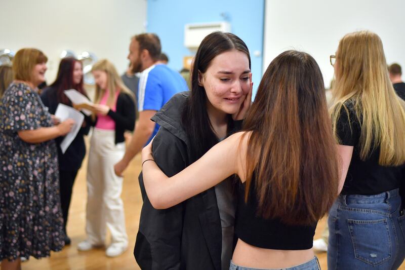 Pupils embrace after receiving their results at Longdendale High School in Hyde, Greater Manchester. Getty Images