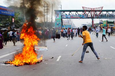 Workers of the Sinha Denim garment factory block the Dhaka-Chattogram highway by setting fires as they protest to demand their due salaries of three months in Kanchpur, on the outskirts of Bangladesh on September 23. Reuters