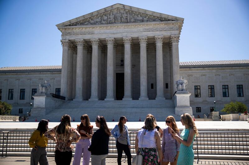 epa09279881 People stand in front of the Supreme Court in Washington, DC, USA, 17 June 2021. The Supreme Court dismissed a challenge to the Affordable Care Act and delivered a unanimous defeat to LGBT couples in a case over whether the city of Philadelphia could refuse to work with a Roman Catholic adoption agency whose religious beliefs prevent it from working with same sex foster parents.  EPA/SHAWN THEW