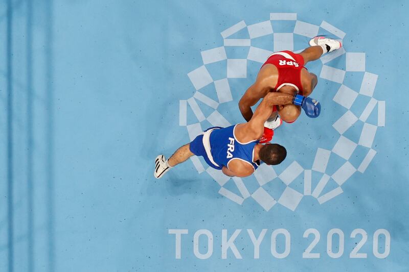 An overview shows France's Mourad Aliev (blue) and Britain's Frazer Clarke fighting during their men's super heavy (over 91kg) quarter-final boxing match.