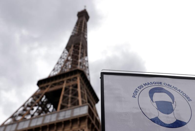 A sign that reads, "Mandatory to wear a mask on all the site", is seen at the entrance of the Eiffel Tower as she gets ready to re-open to the public following the coronavirus outbreak, in Paris, France. Reuters