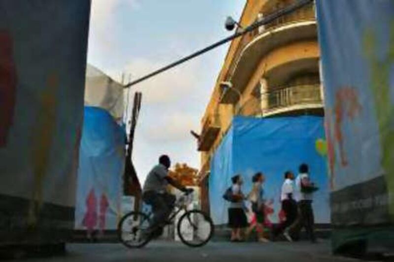 People cross the street near the UN buffer zone in divided Nicosia yesterday.