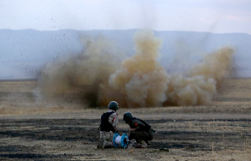 Kurdish Peshmerga fighters detonate a mine laid by ISIS south of Erbil, in northern Iraq. AFP