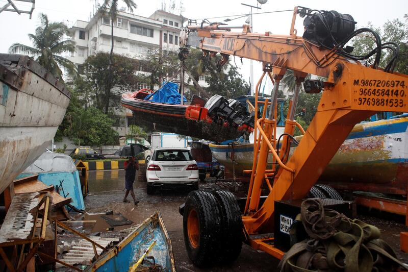 A boat is lifted by a crane as cyclone Nisarga makes its landfall on the outskirts of the city, in Mumbai, India. Reuters