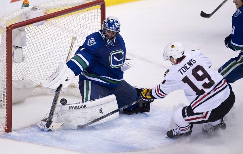 Roberto Luongo, the Vancouver Canucks goalie, left, has had blow-hot-blow-cold performances in the NHL. Jonathan Hayward / AP Photo