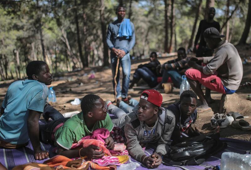 Sub-Saharan migrants trying to get to Europe take shelter in a forest overlooking the neighborhood of Masnana, on the outskirts of Tangier, Morocco. AP