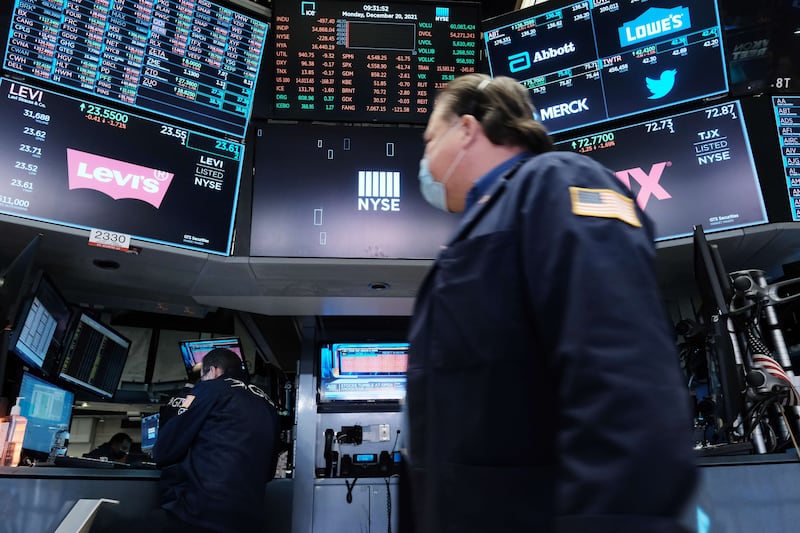 A trader works on the floor of the New York Stock Exchange at the start of trading on Monday after Friday’s steep decline in global stocks amid fears about the Omicron variant.  Stocks fell sharply in morning trading, with the Dow falling more than 500 points. Getty