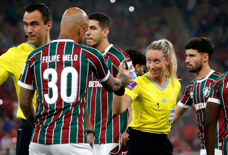 Fourth official Tori Penso shakes hands with Fluminense's Felipe Melo before the match. Reuters