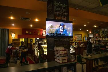 A TV shows a broadcast of the Derek Chauvin murder trial inside a restaurant in Minneapolis, Minnesota. AFP
