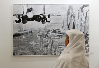 A visitor looks at artworks made by a Palestinian artist at the annual Art Dubai exhibition in Dubai, United Arab Emirates March 21, 2018. Picture taken March 21, 2018. REUTERS/Ahmed Jadallah  NO RESALES. NO ARCHIVES.