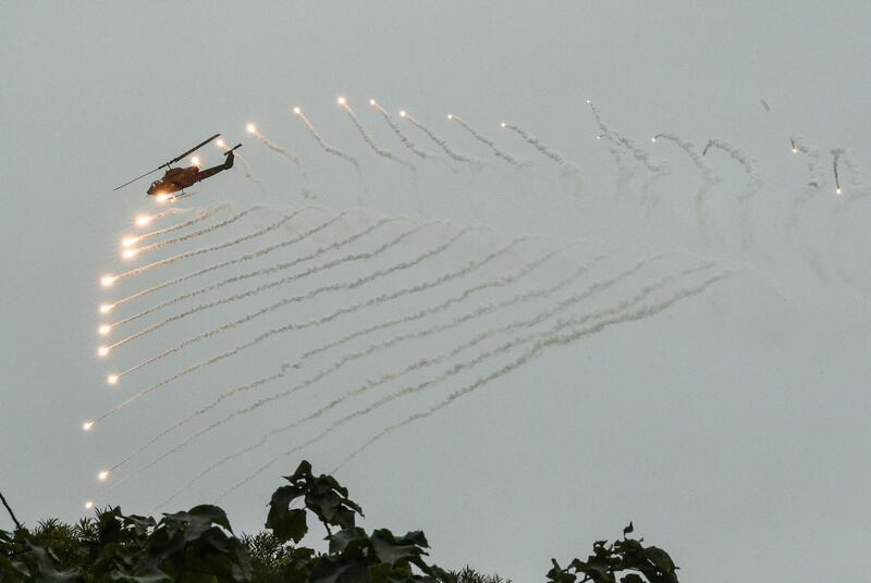 A US-made AH-1W Super Cobra helicopter launches flares during an annual drill at the military base in the eastern city of Hualien. Mandy Cheng / AFP Photo