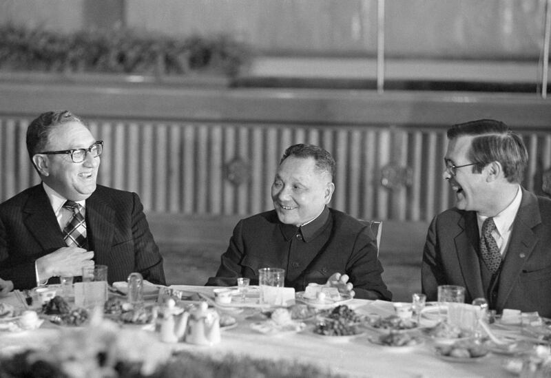 US secretary of state Henry Kissinger, left, Deng Xiaoping, Chinese deputy prime minister, and Donald Rumsfeld sit in the banquet site at the Great Hall of the People in Beijing in 1974. AP Photo
